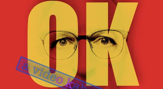 Das Bild hat einen roten Hintergrund mit dem Text "i am OK" in großen gelben Buchstaben. Hinter dem Text sind Augen und eine Brille sichtbar, was dem Bild eine persönliche Note verleiht. Unten steht "martinmarion" und der blaue Stempel "a video kabaret" fügt ein kreatives Element hinzu. Die Gestaltung wirkt modern und ausdrucksstark.